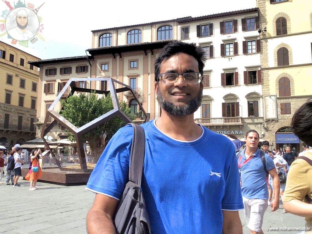 Standing in front of dodecahedron and a mulberry tree on Piazza della Signoria in Florence, Italy